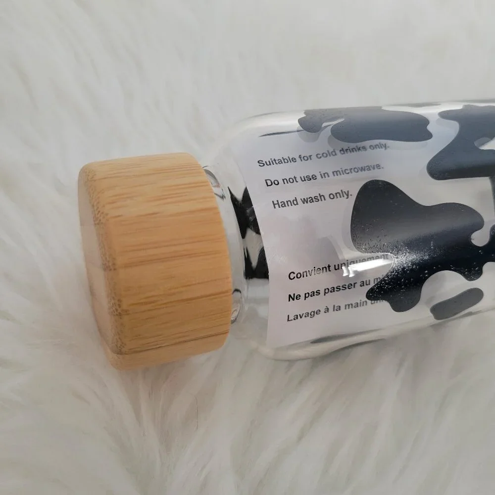 Claire's Cow Print Glass Water Bottle with Sleeve